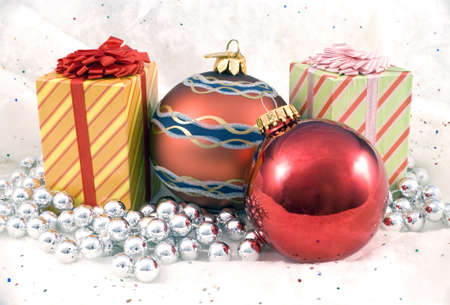 Some Christmas holiday decorations photographed indoors against a snow background.の写真素材