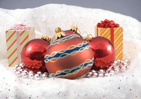 Some Christmas holiday decorations photographed indoors against a snow background.の写真素材