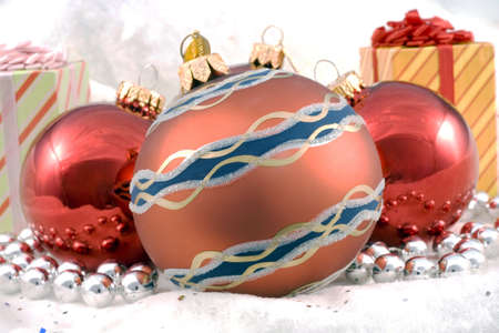 Some Christmas holiday decorations photographed indoors against a snow background.の写真素材