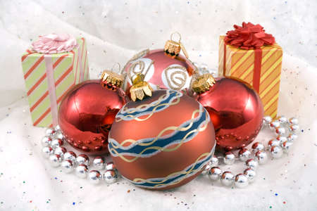 Some Christmas holiday decorations photographed indoors against a snow background.の写真素材