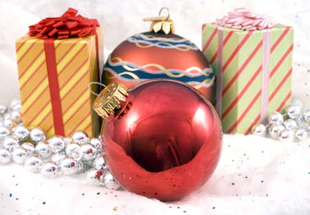 Some Christmas holiday decorations photographed indoors against a snow background.の写真素材