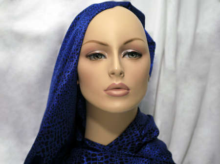  mannequin bust draped with fabric against plain background.の写真素材