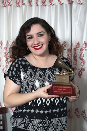 BRONX, NEW YORK - DECEMBER 23: Yomo Toro's niece Christina holds  Latin Grammy in honor of international cuatro player Yomo Toro who was awarded the Grammy but passed away before he could accept it. Taken December 23, 2012 in the Bronx, NY.のeditorial素材
