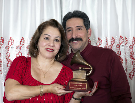 BRONX, NEW YORK - DECEMBER 23: Yomo Toro's niece Elizabeth and her husband Andy hold  Latin Grammy in honor of international cuatro player Yomo Toro who was awarded the Grammy but passed away before he could accept it. Taken December 23, 2012 in the Bronxのeditorial素材