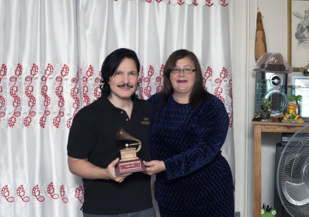 BRONX, NEW YORK - DECEMBER 23: Yomo's wife Minerva and nephew Eddie Toro remember international cuatro player Yomo Toro who was awarded the Latin Grammy but passed away before he could accept it. Taken December 23, 2012 in the Bronx, NY.のeditorial素材