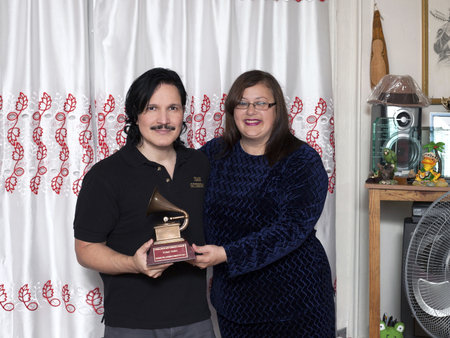 BRONX, NEW YORK - DECEMBER 23: Yomo's wife Minerva and nephew Eddie Toro remember international cuatro player Yomo Toro who was awarded the Latin Grammy but passed away before he could accept it. Taken December 23, 2012 in the Bronx, NY.のeditorial素材