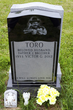 QUEENS, NEW YORK - JUNE 6: Grave of Yomo Toro, master of the Puerto Rican guitar like instrument called a cuatro.   Taken June 6, 2013 at Saint Michael's Cemetery in New York.のeditorial素材