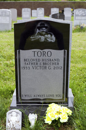 QUEENS, NEW YORK - JUNE 6: Grave of Yomo Toro, master of the Puerto Rican guitar like instrument called a cuatro.   Taken June 6, 2013 at Saint Michael's Cemetery in New York.のeditorial素材