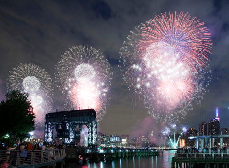 QUEENS, NEW YORK - JULY 4: Macy's independence day firework celebration in NYC as viewed from Gantry Plaza State Park in Long Island City.   Taken July 4, 2015 in Queens, NY.のeditorial素材