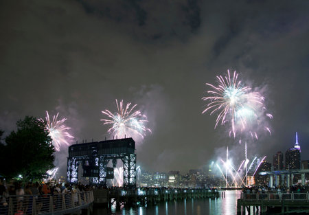 QUEENS, NEW YORK - JULY 4: Macy's independence day firework celebration in NYC as viewed from Gantry Plaza State Park in Long Island City.   Taken July 4, 2015 in Queens, NY.のeditorial素材