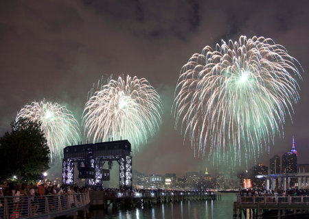 QUEENS, NEW YORK - JULY 4: Macy's independence day firework celebration in NYC as viewed from Gantry Plaza State Park in Long Island City.   Taken July 4, 2015 in Queens, NY.のeditorial素材