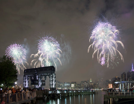 QUEENS, NEW YORK - JULY 4: Macy's independence day firework celebration in NYC as viewed from Gantry Plaza State Park in Long Island City.   Taken July 4, 2015 in Queens, NY.のeditorial素材