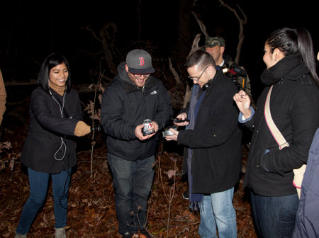 HUNTINGTON, NEW YORK, USA - NOVEMBER 14,  2015: Members of the Brooklyn Paranormal Society of NY during their investigation of Mount Misery Road in Long Island. Known for tales and legends of paranormal sightings.  They are standing and taking readings onのeditorial素材