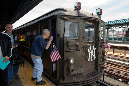 BRONX, NEW YORK, USA - APRIL 10:  Blind man asks directions from conductor of Low Voltage vintage train at Yankee Stadium used for opening day game.  Taken April 10, 2017 in New York.のeditorial素材