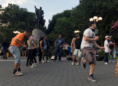 NEW YORK, NEW YORK, USA - AUGUST 25: People dance in front of George Washington statue inside Union Square park and 14th street.  Taken August 25, 2017 in New York.のeditorial素材