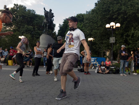NEW YORK, NEW YORK, USA - AUGUST 25: People dance in front of George Washington statue inside Union Square park and 14th street.  Taken August 25, 2017 in New York.のeditorial素材