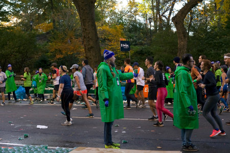 NEW YORK, NEW YORK/USA - November 4, 2018: Woman holds out water to runners participating in marathon. .のeditorial素材