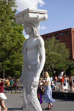 NEW YORK, NEW YORK/USA - June 22, 2019: Street mime posing as statue at Washington Square Park in Manhattan.のeditorial素材