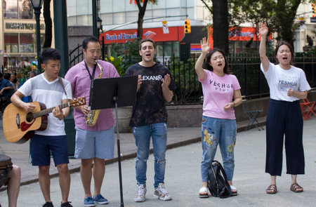 NEW YORK, NEW YORK/USA - July 27, 2019: Members of Church of Jesus sing praise songs during evangelizing event on Herald Square.のeditorial素材