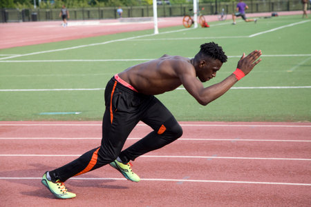 BRONX, NEW YORK/USA - August 5, 2019: Black male athlete makes a practice run on park track near Yankee Stadium.のeditorial素材