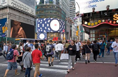 NEW YORK, NEW YORK/USA - July 2, 2019: Pedestrians cross street in busy Manhattan.のeditorial素材