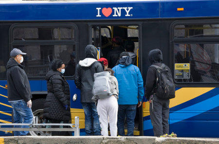 BRONX, NEW YORK/USA - April 20, 2020: People forced to board rear of MTA bus with no fare collection...