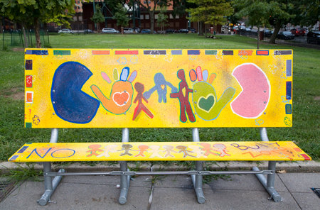 BRONX, NEW YORK/USA - September 5, 2019: Public park bench art by students of Lewis and Clark School 12x called "Friends over Bullies", artist Angelina Amankwa.のeditorial素材