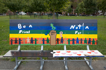 BRONX, NEW YORK/USA - September 5, 2019: Public park bench art by students of Mosholu Parkway School 80X called "Be a friend, not a foe",  artist Iviva Olenick.のeditorial素材