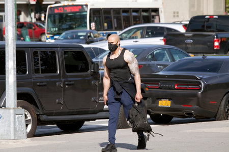 BRONX, NEW YORK, USA - May 20, 2020: Muscular and tattooed man wearing mask against Covid-19.のeditorial素材