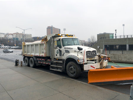 BRONX, NEW YORK, USA - January 28, 2022: A sanitation truck stands by with salt and a attached shovel for coming snow storm.のeditorial素材