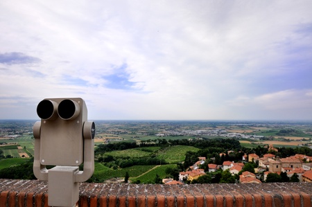 a view from a panoramic terrace of a typical village of Romagna, Italy with a binocular on the leftの写真素材
