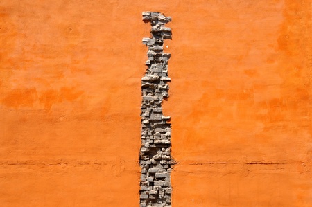 Crack of bricks in orange wallの写真素材