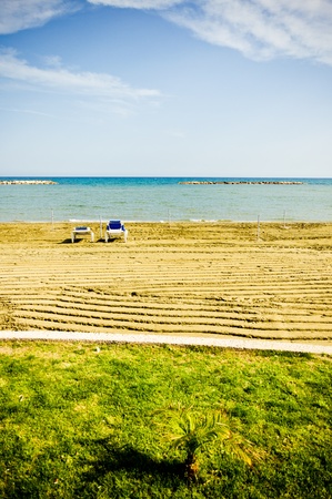 empty sunbeds during low seasonの写真素材
