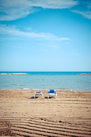 empty sunbeds during low seasonの写真素材