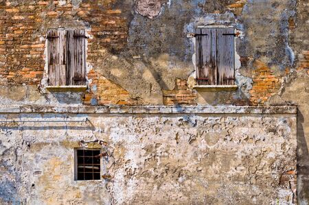 old windows in ruined wall (concept: abandoned, decadence)の写真素材