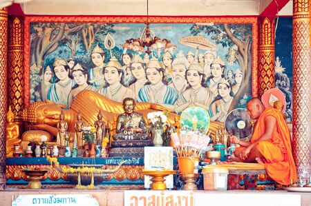 KO SAMUI, THAILAND - AUGUST 7  Buddhist monk prays in Big Buddha temple, Koh Samui - Thailand on August 7, 2012  This temple is the home of Koh Samui most famous landmark, the Big Buddha, the 12 meter tall golden statue visible from several kilometers awaのeditorial素材