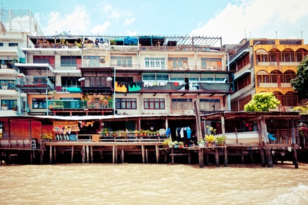 BANGKOK, THAILAND - AUGUST 08: residential buildings seen from boat along the Chao Phraya River in Bangkok on 08 august 2012のeditorial素材