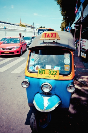 BANGKOK, THAILAND - AUGUST 11: typical Thai tuk tuk taxy on the road on august 11, 2012 in Bangkok, Thailand.のeditorial素材