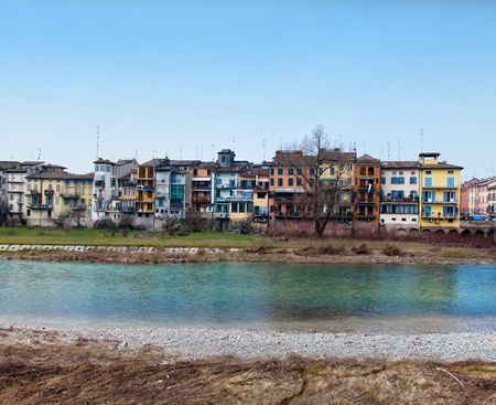 Parma river with typical city houses and bridge in winter dayの写真素材