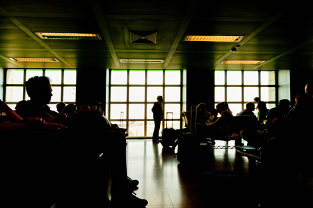 MILAN, ITALY - JUNE 07  silhouettes of people waiting at the plane boarding gates at Milan Linate airport on June 07, 2013; Linate Airport is one of the three major airports of Milan, Italyのeditorial素材