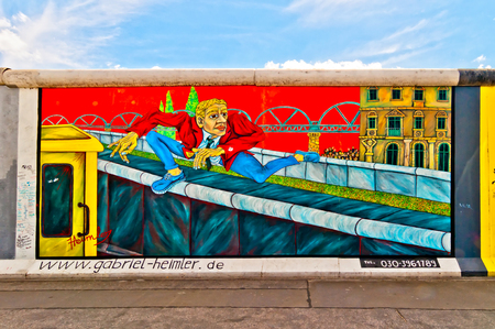 BERLIN, GERMANY - JUNE 10   memorable segment of the Wall with work of artist Gabriel Heimler on June 10, 2013 in Berlin, Germany  This work represents the Mauerspringer, the jumper over Berlin Wall のeditorial素材