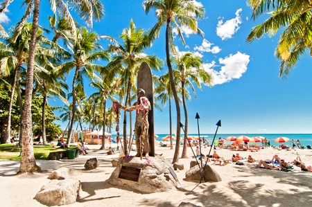 WAIKIKI, HAWAII - SEPTEMBER 7, 2013  Tourists sunbathing and surfing on Waikiki beach in Honolulu, Hawaii  Waikiki white sand beach shoreline is Hawaii s most famous beach のeditorial素材