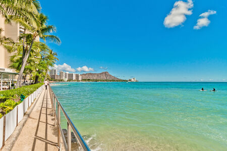 WAIKIKI, HAWAII - SEPTEMBER 7, 2013  Tourists sunbathing and surfing on Waikiki beach in Honolulu, Hawaii  Waikiki white sand beach shoreline is Hawaii s most famous beach のeditorial素材