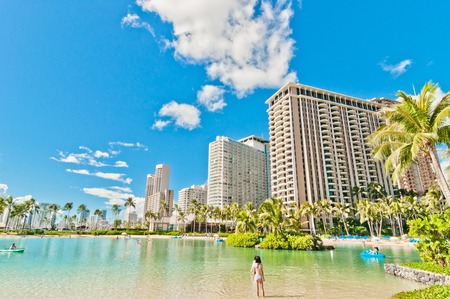 WAIKIKI, HAWAII - SEPTEMBER 7, 2013  Tourists sunbathing and surfing on Waikiki beach in Honolulu, Hawaii  Waikiki white sand beach shoreline is Hawaii s most famous beach のeditorial素材
