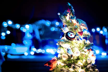 decorated Christmas tree with de-focused lights backgroundの写真素材