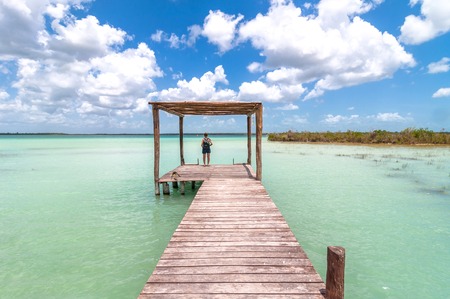 idyllic pier and palapa hut in Bacalar lagoon, Mexicoの写真素材
