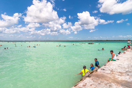 Bacalar, Mexico - April 26, 2014: locals and tourists enjoy turquoise water at Balneario magico in Bacalar lagoon, Mexico. Bacalar is known for its natural caribbean laguna that changes 7 colours のeditorial素材