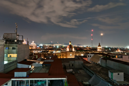 Mexico City, Mexico - April 29, 2014: night view of skyline with brightly lit suburban barrios in the background in Mexico City, Mexico. The city is located at an altitude of 2,240 meters.のeditorial素材