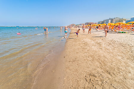 CERVIA, ITALY - June 7, 2014: people on the beach in Cervia, Emilia Romagna, Italy. At the start of the summer the beaches of Riviera Romagnola get full of people.のeditorial素材