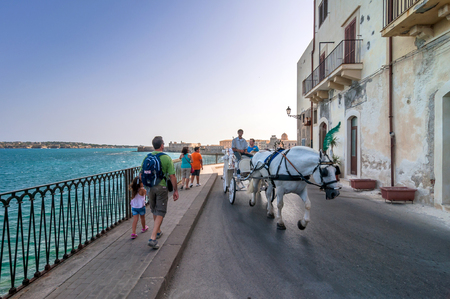 SYRACUSE, ITALY - AUGUST 20, 2014: tourists visit Ortigia in Syracuse, Italy. Ortigia is a small island which is the historical centre of the city of Syracuse, Sicily.のeditorial素材